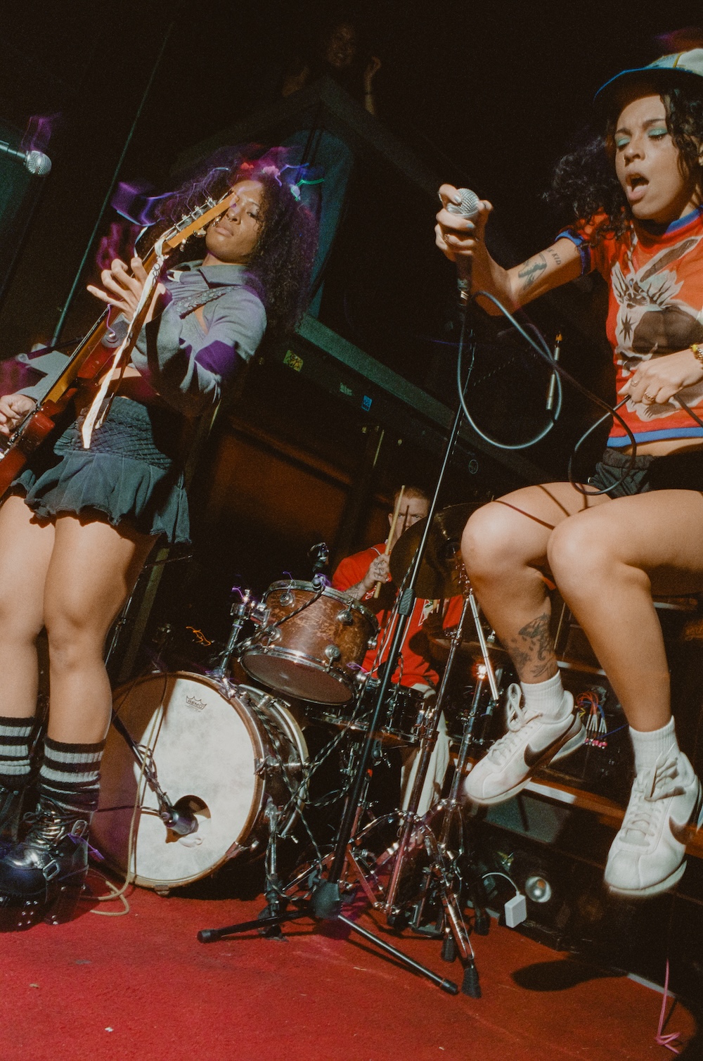 frontwoman Kyra mid song. Kyra is jumping in the air.